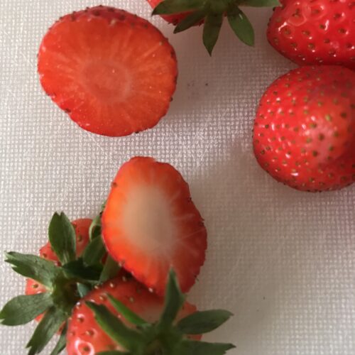 Whole strawberries with chopped off strawberry tops