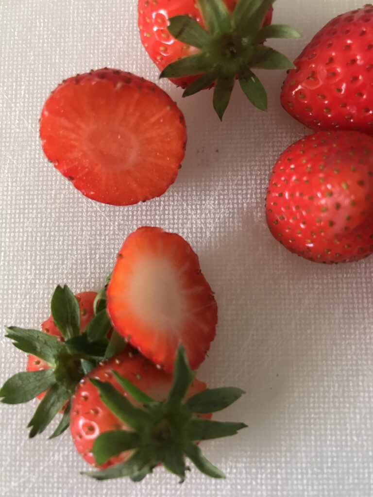 Whole strawberries with chopped off strawberry tops