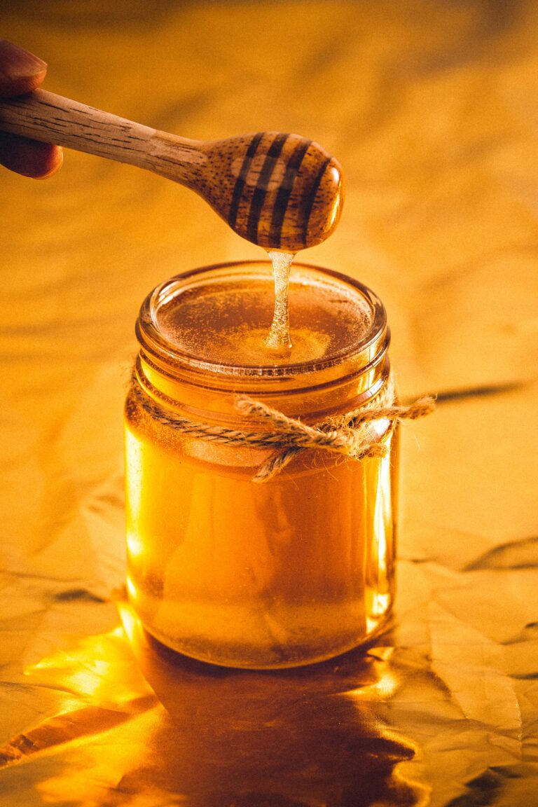 Jar of honey with honey spoon