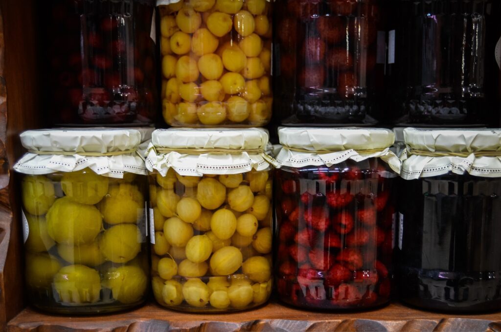 jars of preserved fruits and vegetables on shelf