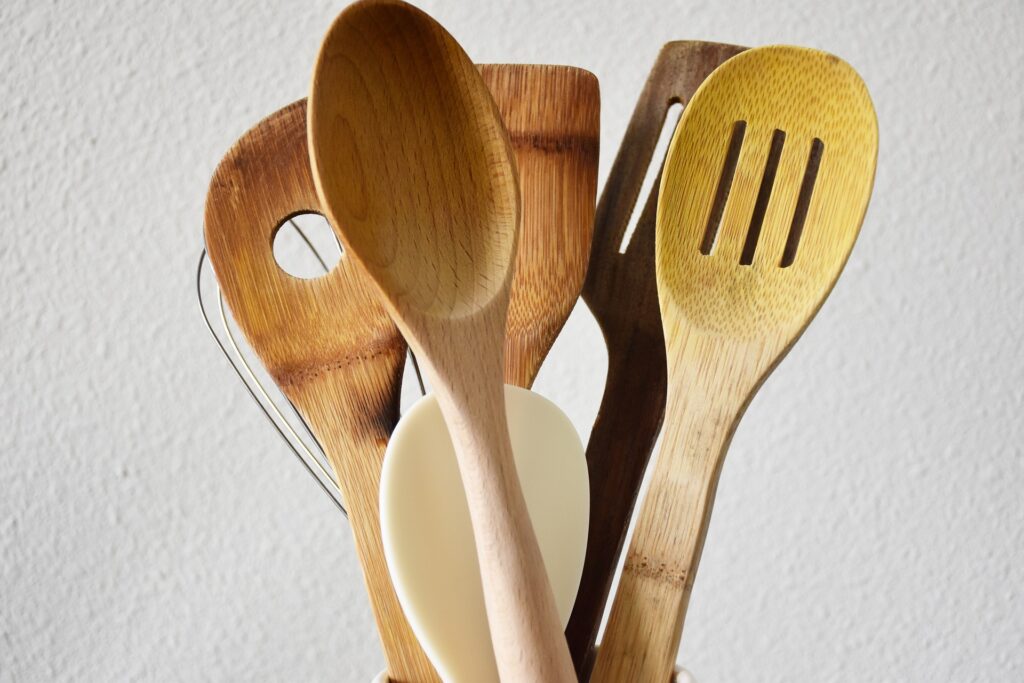 A basket of wooden kitchen spoons