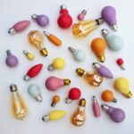 A collection of opaque coloured lightbulbs on a white back-ground