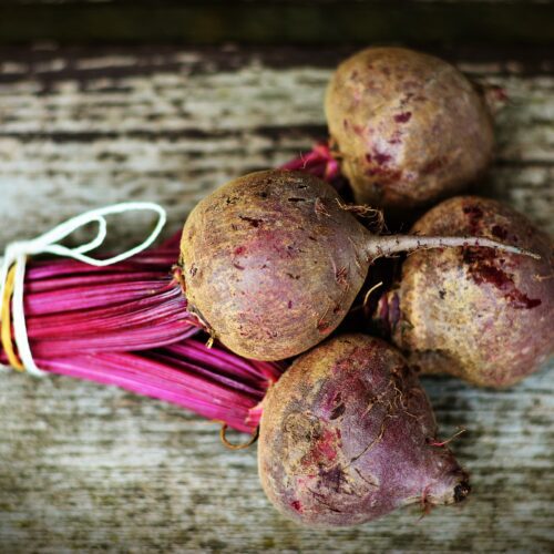 Beetroot bulbs on a board