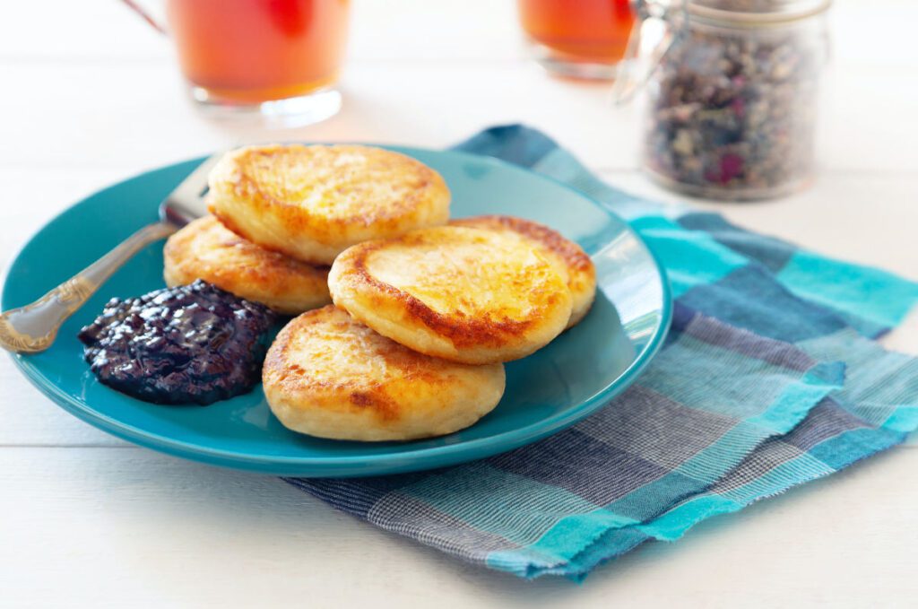 Blackcurrant curd with toasted crumpets on blue plate