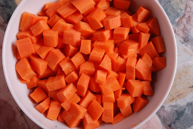 Chopped carrots in a white bowl.