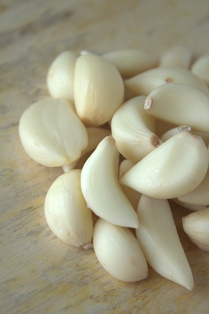 Peeled garlic cloves on a wooden board