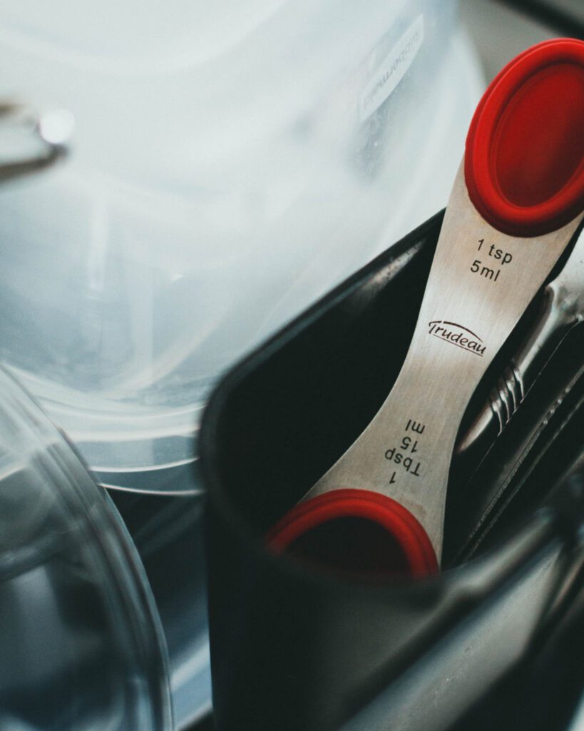 Chrome and red plastic measuring spoon