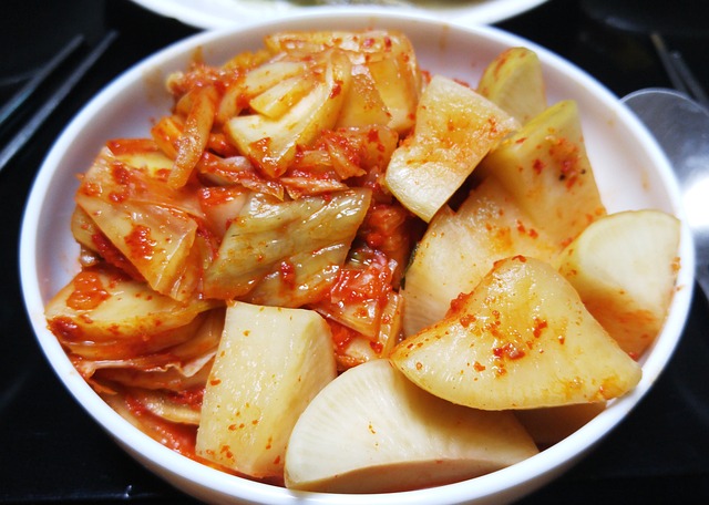 A white bowl of fermented vegetables