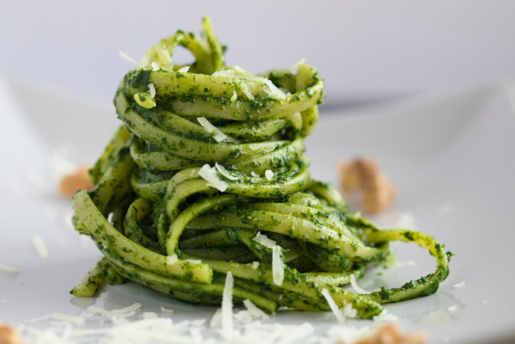 Rocket and walnut pesto pasta stack with grated parmesan garnish