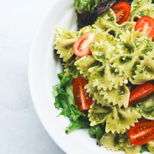 Rocket and walnut pesto pasta salad with tomatoes.