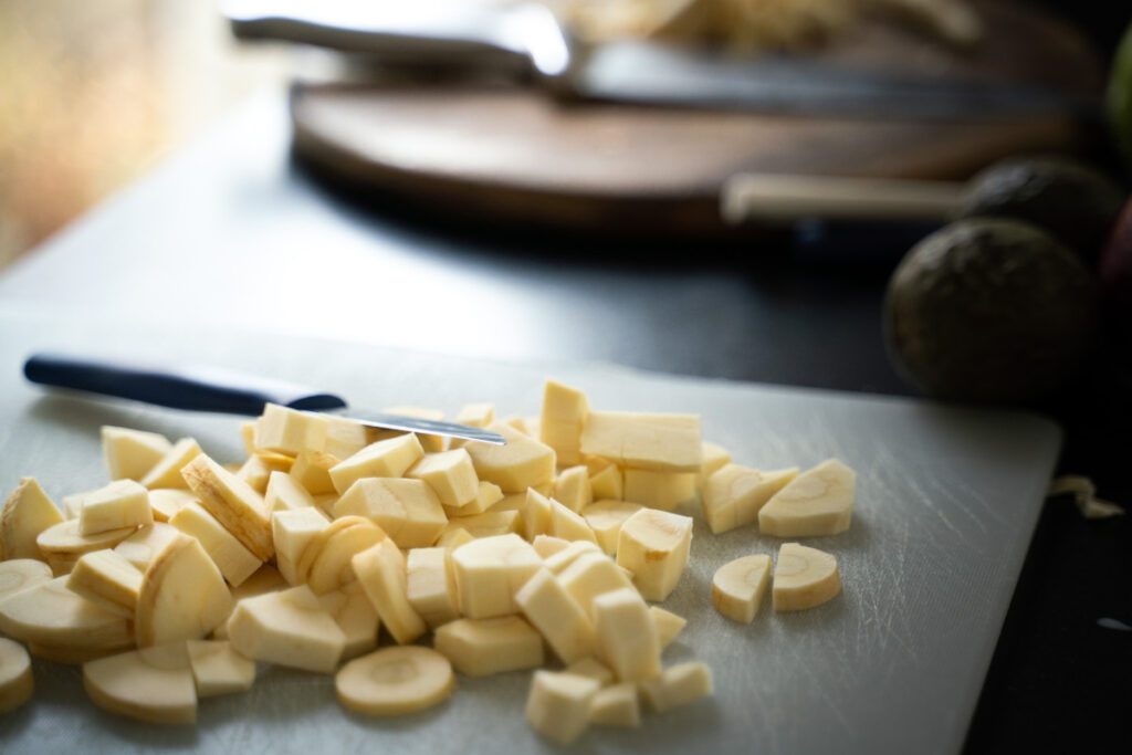 Pieces of chopped parsnips on a board.