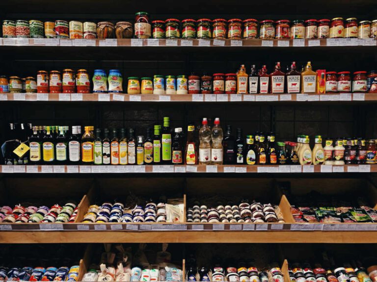 Condiment shelf in a shop. Rows and rows of jars and bottles.