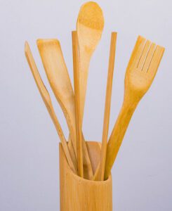 Long-handled wooden spoon and spatulas in a wooden holder