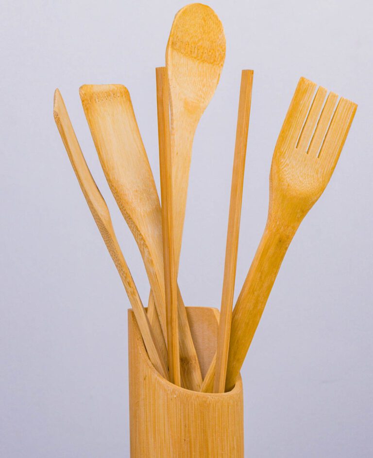 long handles wooden spoon and spatulas in a wooden holder